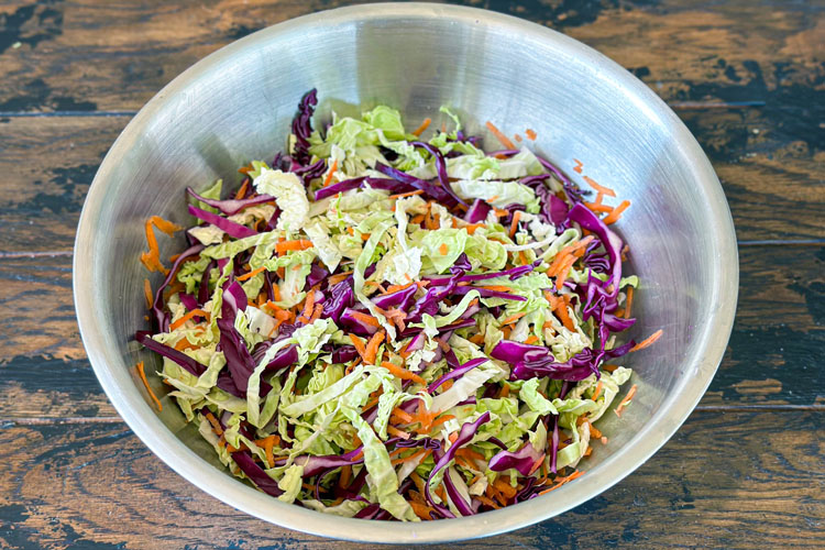cabbage and carrot mixed up in a silver bowl