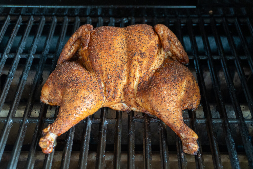 a cooked smoked spatchcock chicken in the smoker 