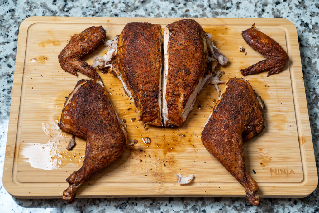 a cooked spatchcock chicken cut up for serving