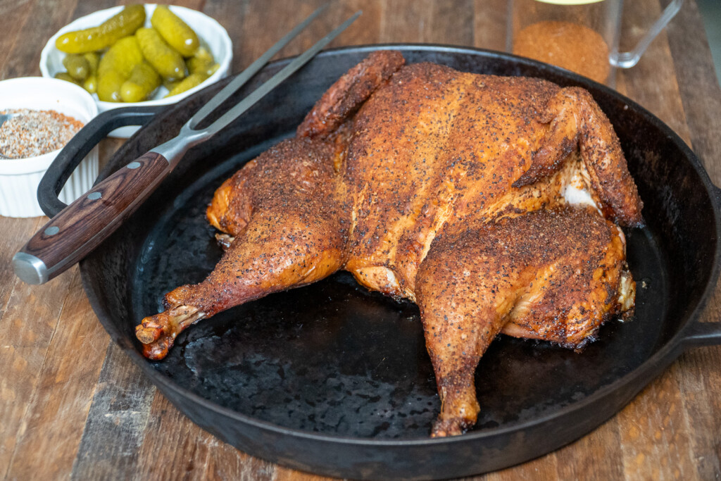 a cooked spatchcocked chicken in a cast iron pan