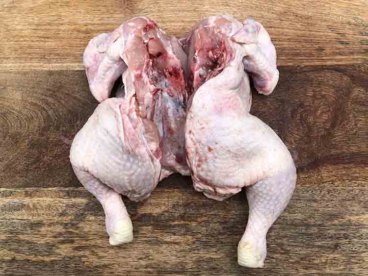 raw chicken with backbone removed