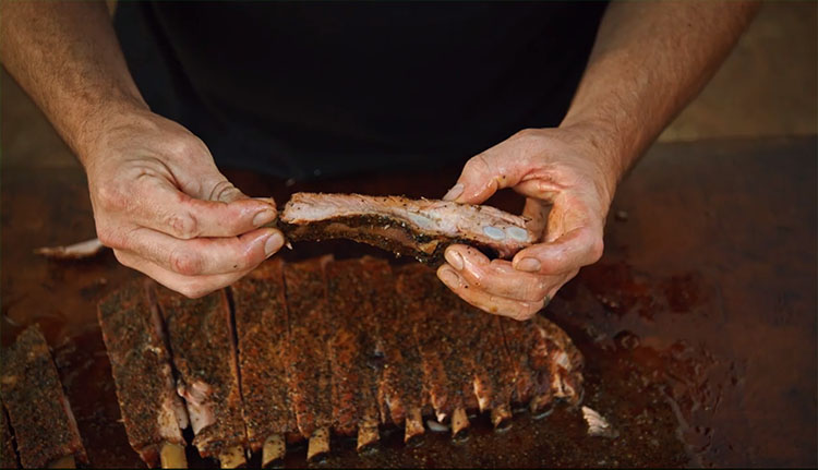 Aaron Franklin holding bbq pork ribs