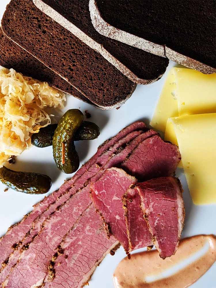 pastrami platter with rye, swiss cheese and sauerkraut