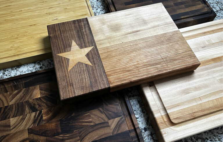 Collection of different wood butcher blocks placed on kitchen counter
