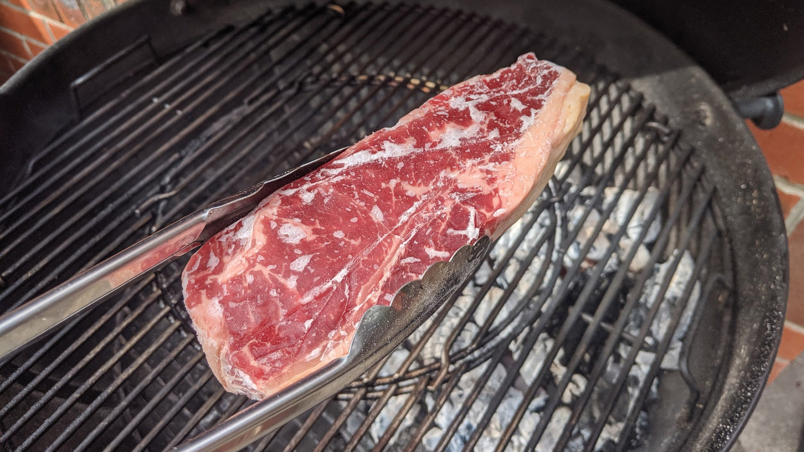Frozen steak on grill