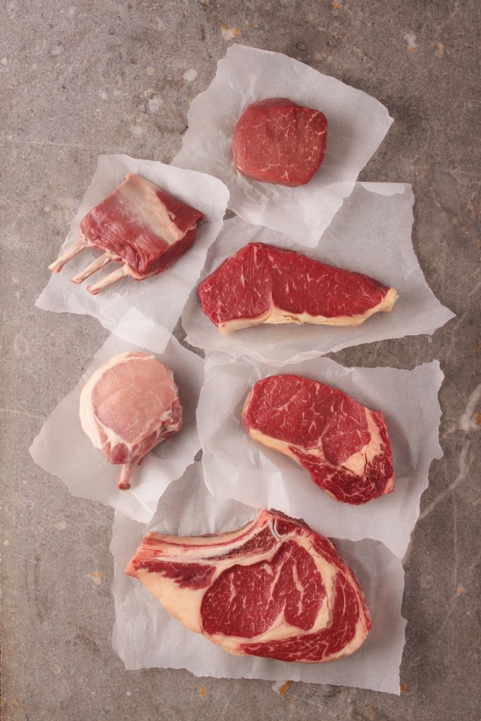Raw red meat cuts on a white paper