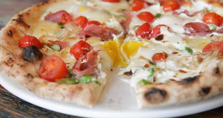 Pizza with tomatoes and eggs