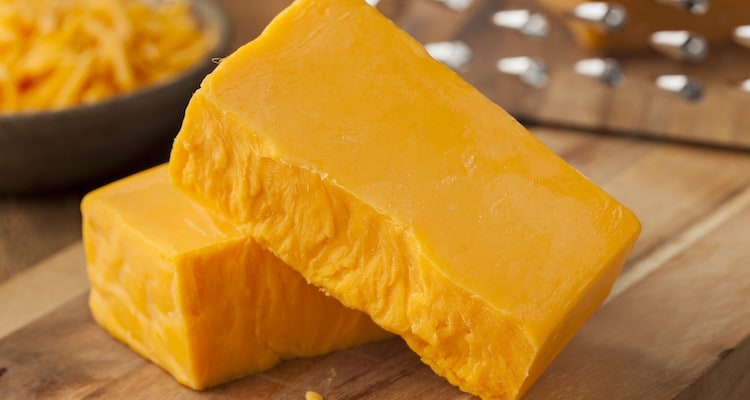 Pieces of smoked cheese on a wooden board