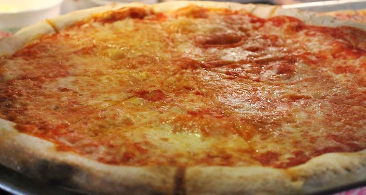 Cheese pizza cut in slices