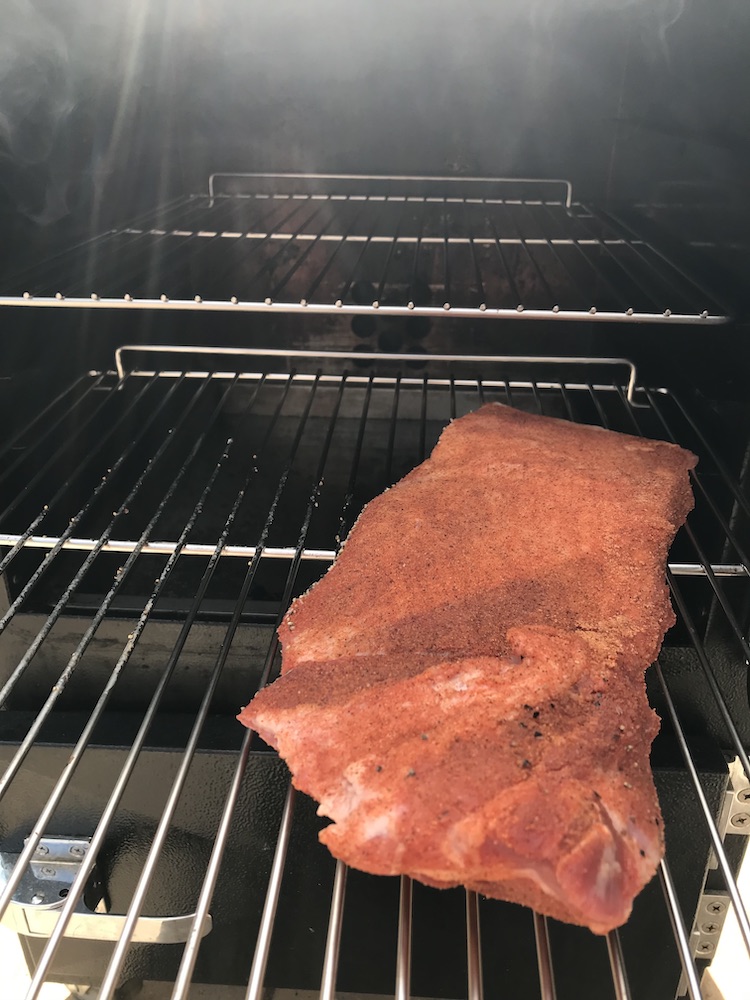 pork brisket in a smoker