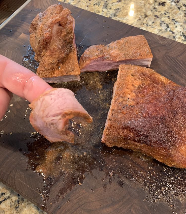 smoked pork brisket on a wooden board