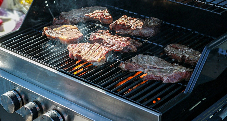 meat cooking on a gas grill