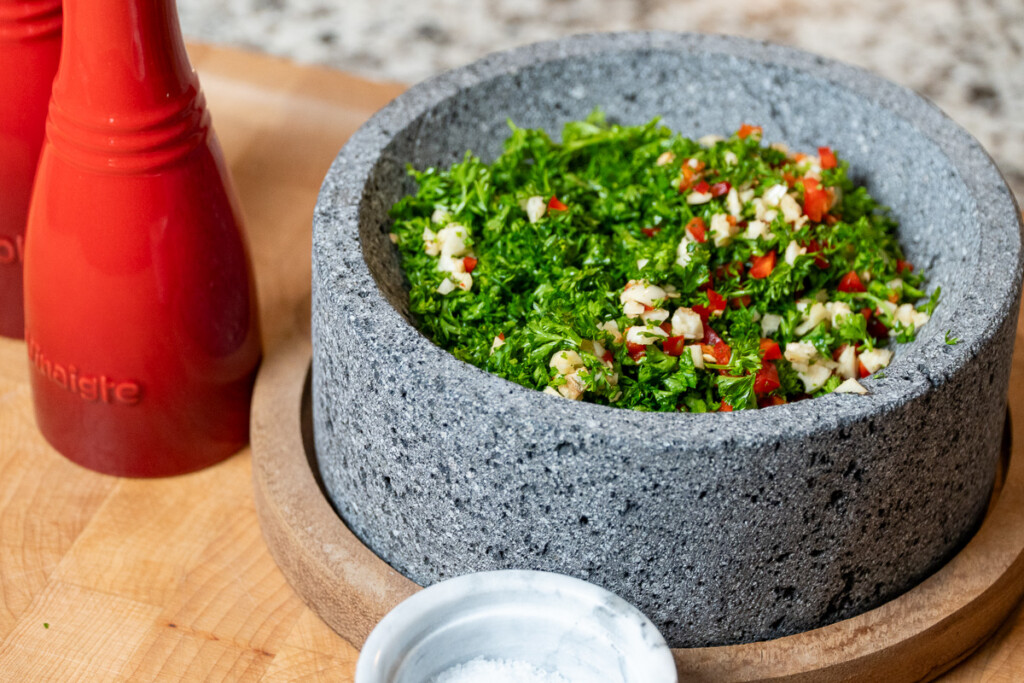 parsley, garlic, jalapeno mixed together in a grey bowl