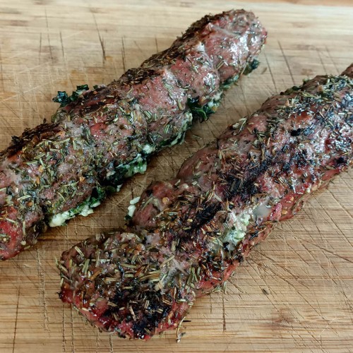 stuffed lamb backstraps on a wooden board