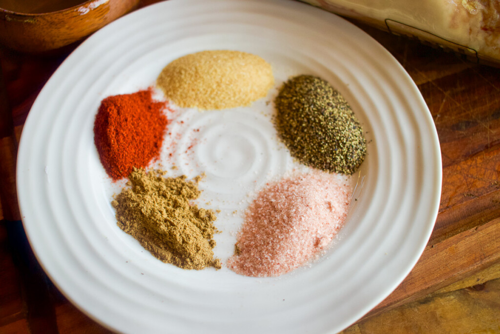 the seasoning for the rub in piles on a white plate