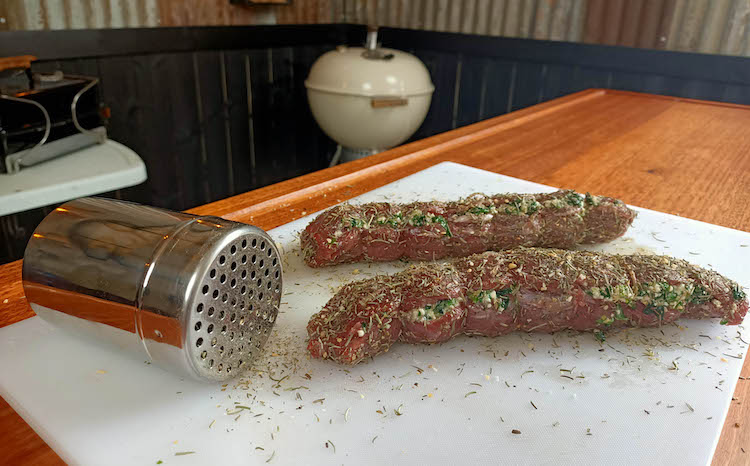 uncooked stuffed lamb backstraps with seasoning