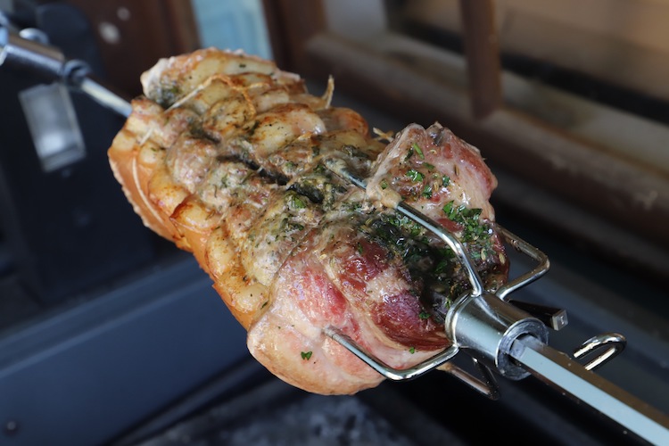 cooked pork belly on a rotisserie