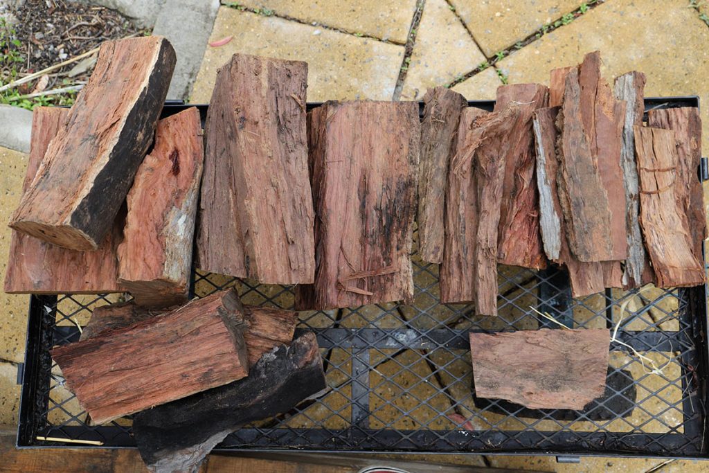 hardwood for pizza oven on a metal rack