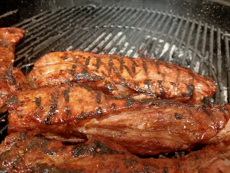 cooked Char Siu pork on a weber kettle