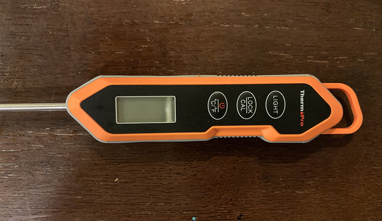 ThermoPro TP15H instant read meat thermometer on a wooden table