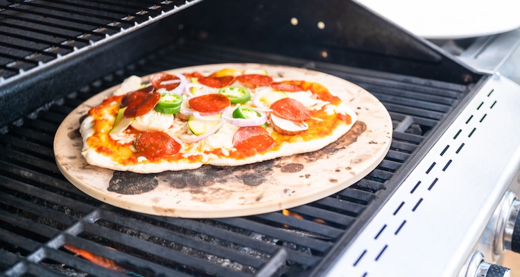 pizza cooking on a pizza stone
