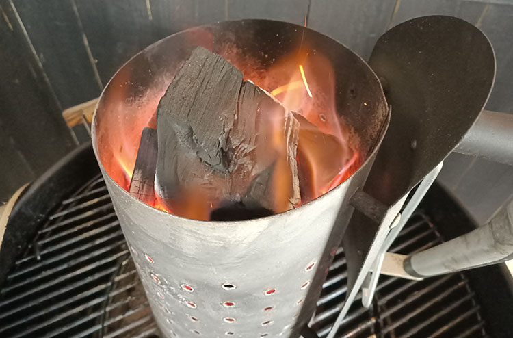 charcoal chimney with burning lump charcoal