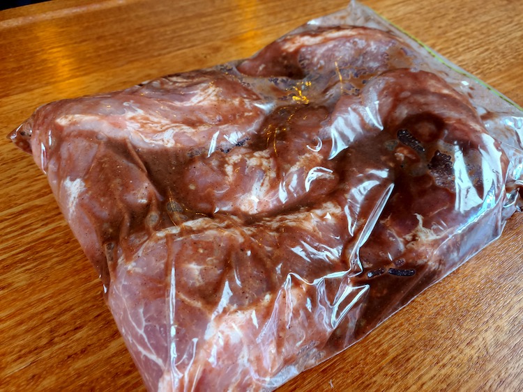 pork collar in Char Siu marinade in a plastic bag