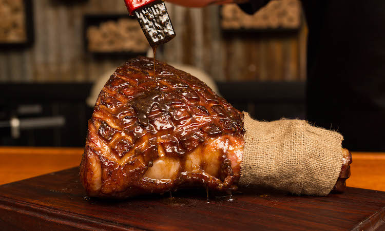 applying glaze to the ham