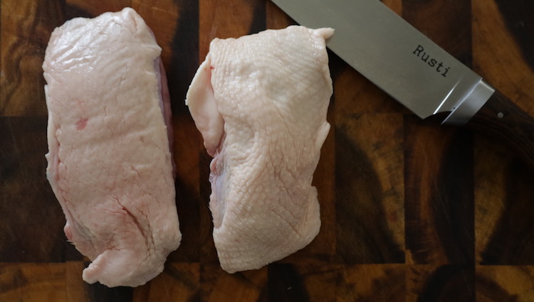 duck breasts on a wooden board