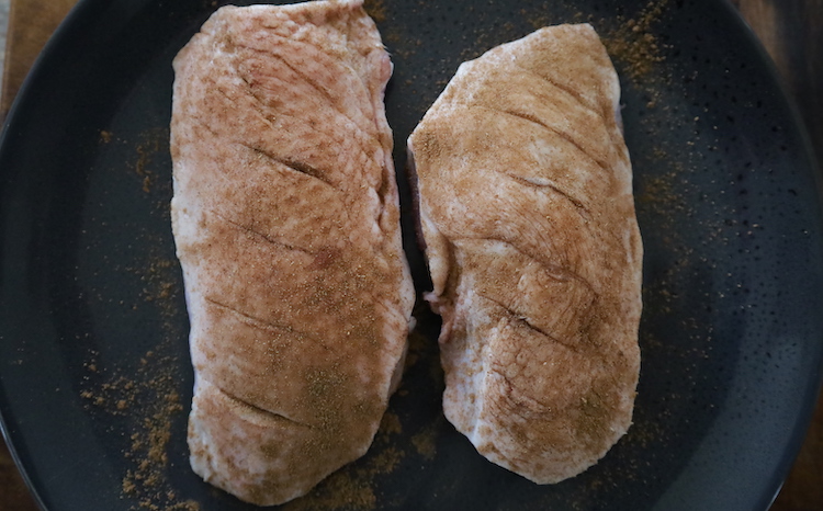 seasoned duck breasts on a plate