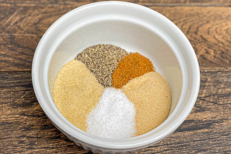 white bowl with dry ingredients for sauce in it