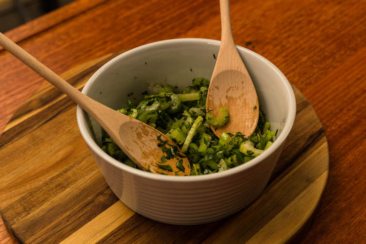 celery and parmesan salad in a white bowl