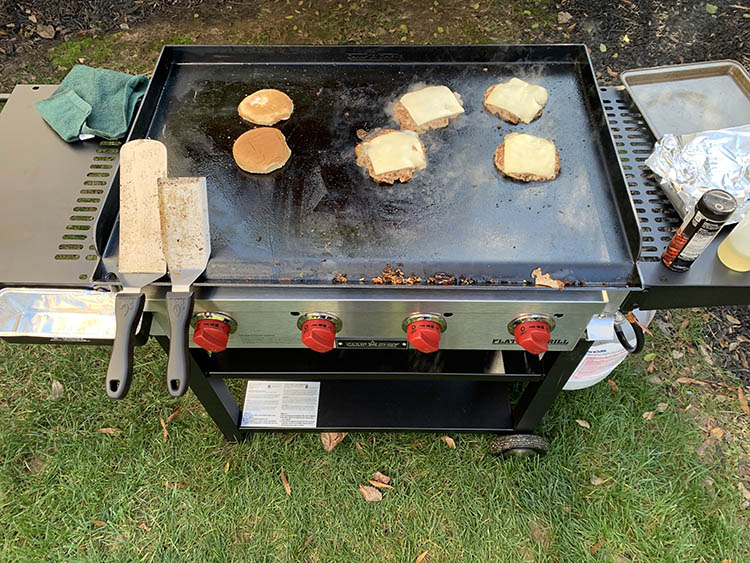 burgers cooking on a Camp Chef Flat Top Grill