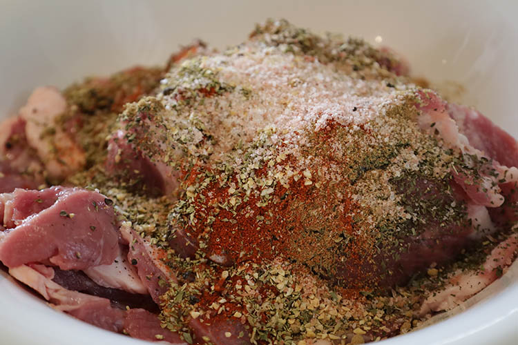 raw lamb shoulder slices in a marinade