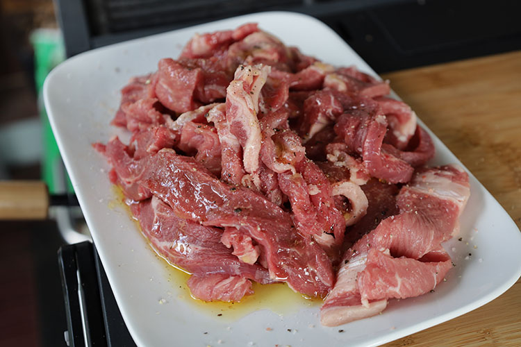 steak slices drizzled with oil on a plate