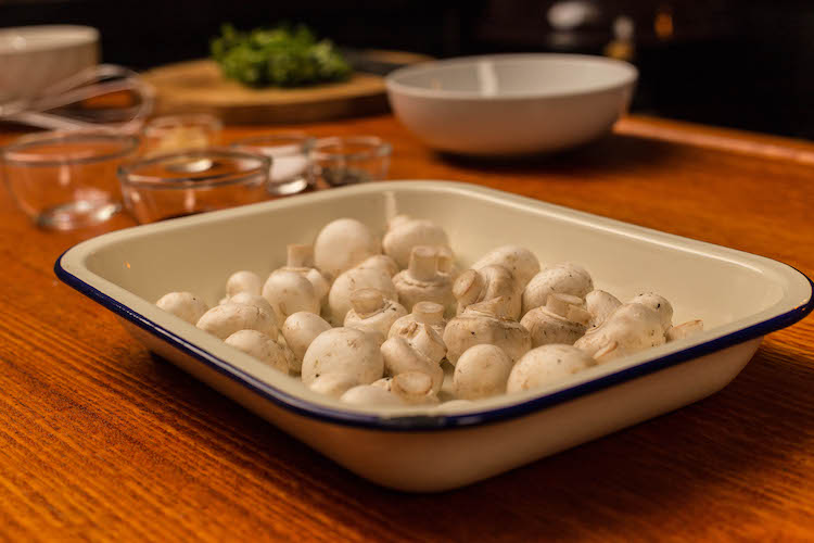 white button mushrooms in a baking tray