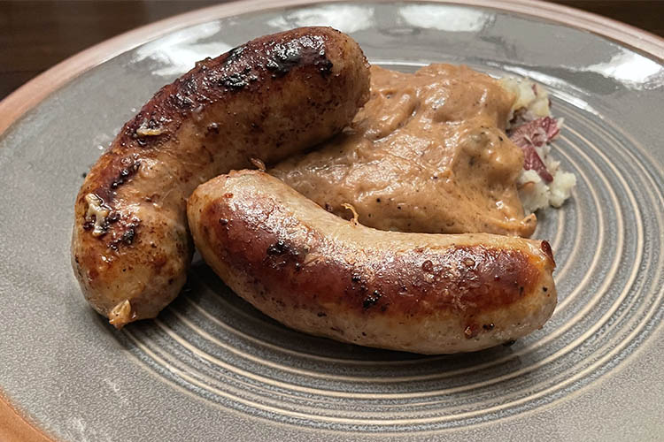 Irish sausage and smashed potatoes on a plate