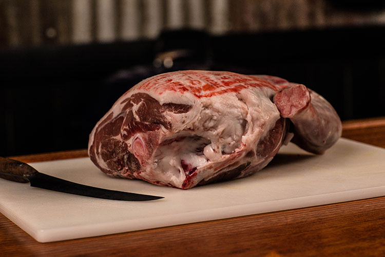 uncooked bone-in leg of lamb