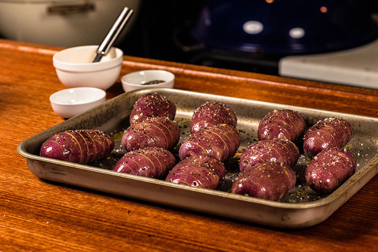 buttered potatoes on a metal tray