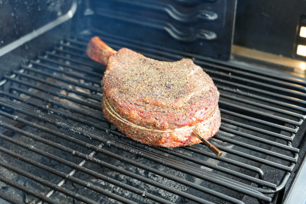 a cooked tomahawk steak on the smoker