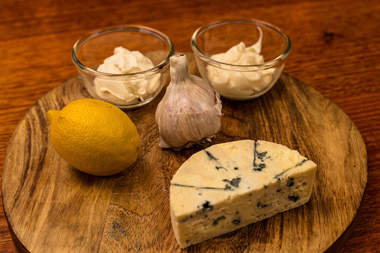 blue cheese sauce ingredients on a wooden board