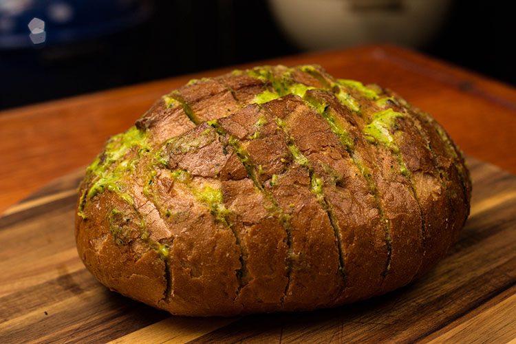 cooked cilantro garlic bread on a wooden board