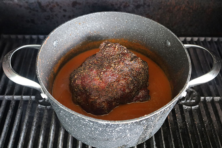 smoked beef chuck in consomme in a pot
