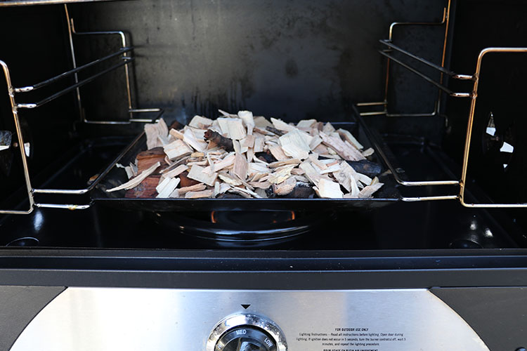 Wood chips inside a smoke box of the Camp Chef Smoke Vault