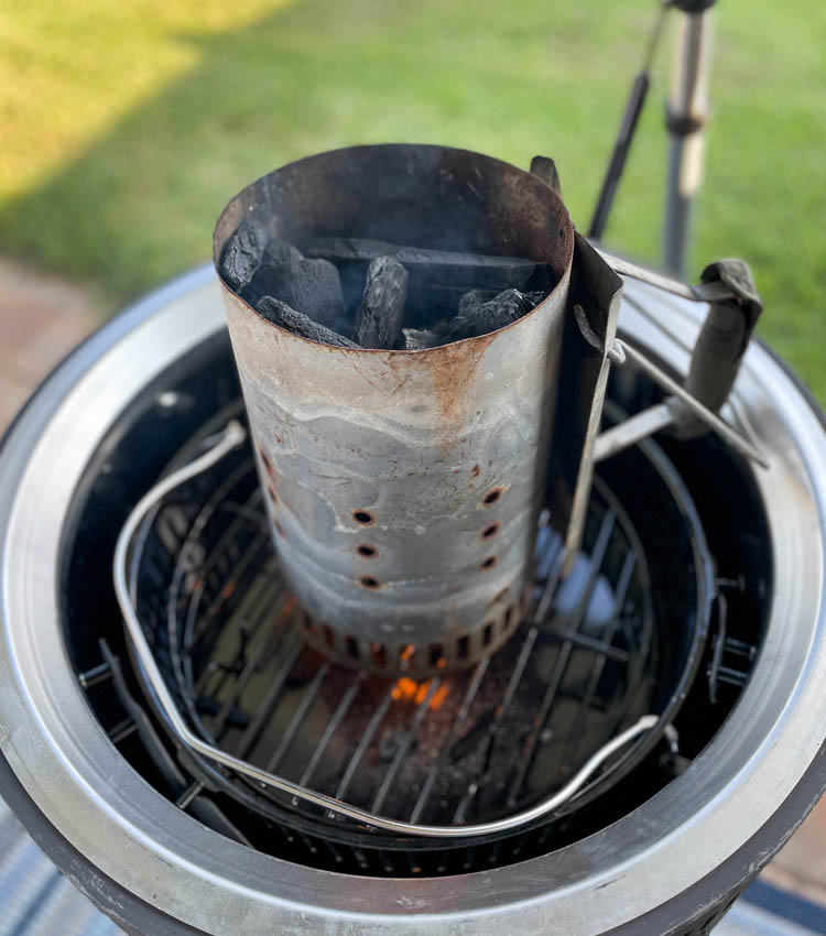unlit coals in a chimney starter on smoker