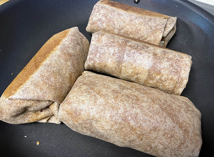 brisket breakfast burrito on a frying pan