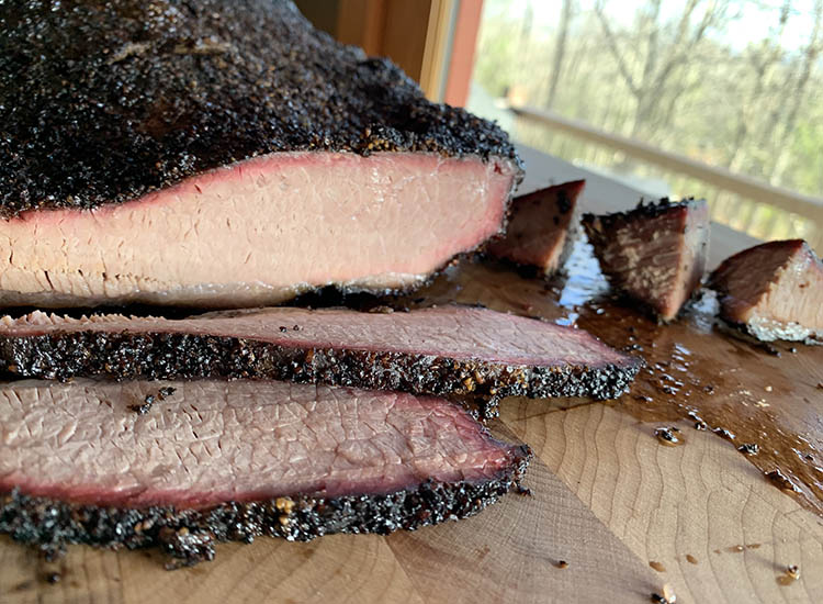sliced brisket on a wooden board
