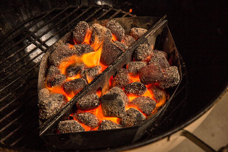 two charcoal baskets full of lit charcoal briquettes 