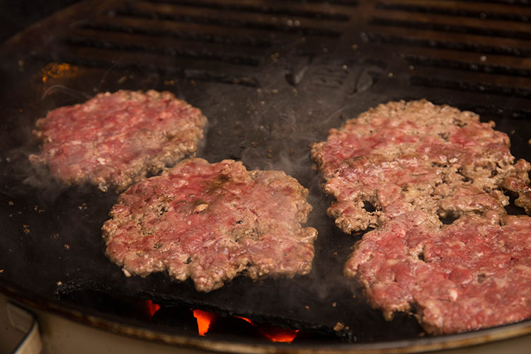 smash burger patties on a hotplate