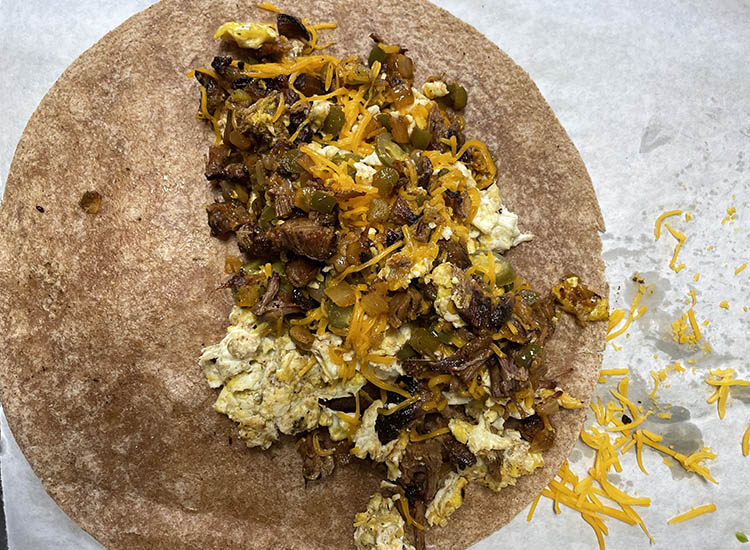 tortilla with veggies, eggs and meat filling